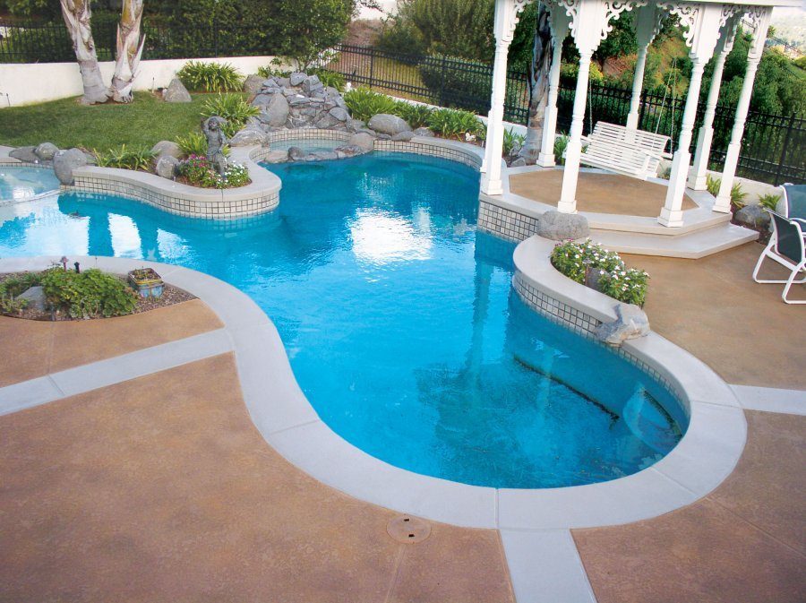 Concrete spray texture system used around a pool.